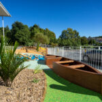 Playground with a boat, vegetation rubber and bark surface